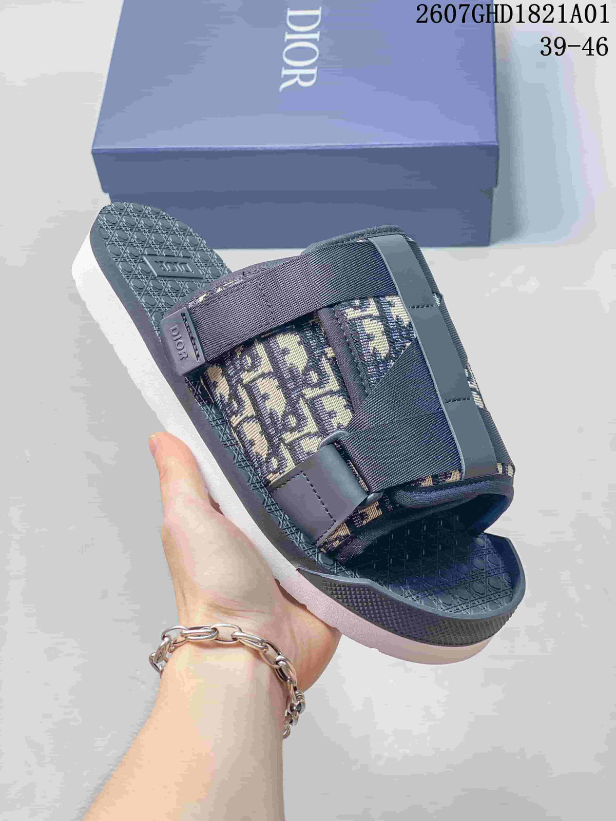 Close view of a grey Oblique-pattern sandal with layered straps and branded detail; image shows size range 39–46.