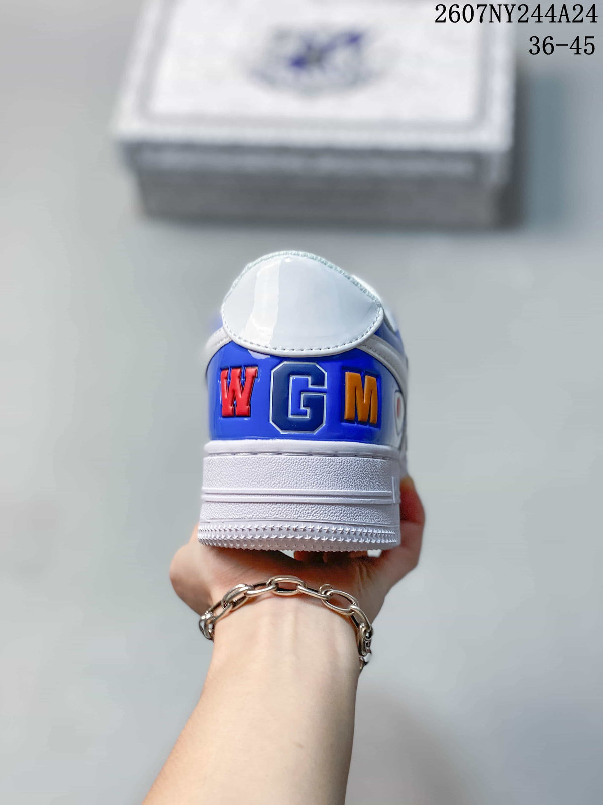 Rear view showing the blue heel panel with multicolored letter details and a white midsole.