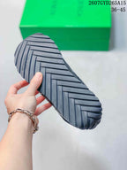Close-up of the sneaker outsole showing a textured, directional tread pattern and embossed branding.