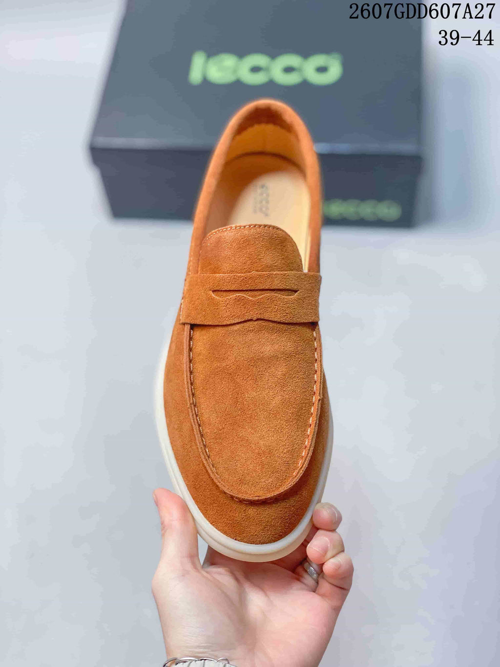 Top view of a brown loafer showing the rounded moc toe, penny strap, and visible stitching.