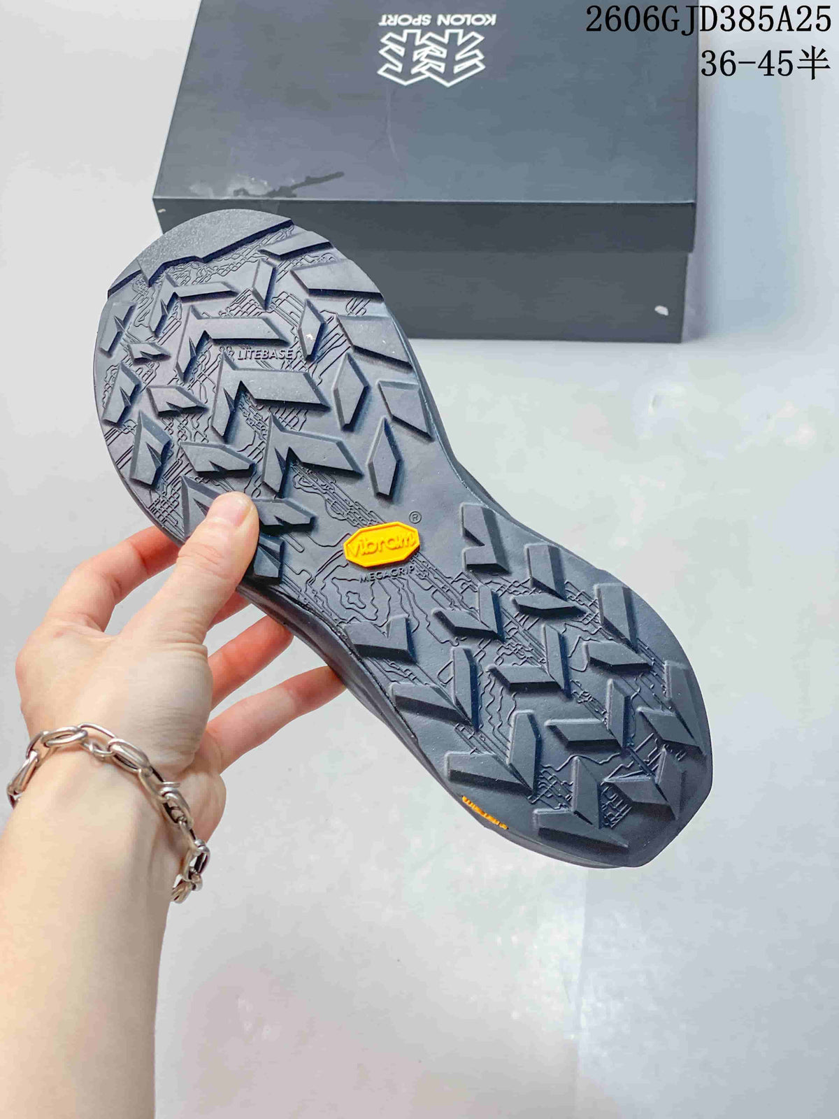Close-up of the lugged outsole with a visible Vibram Megagrip marking.