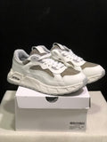 Pair of white and grey low-top sneakers displayed on a shoebox; the box label shows size 41.
