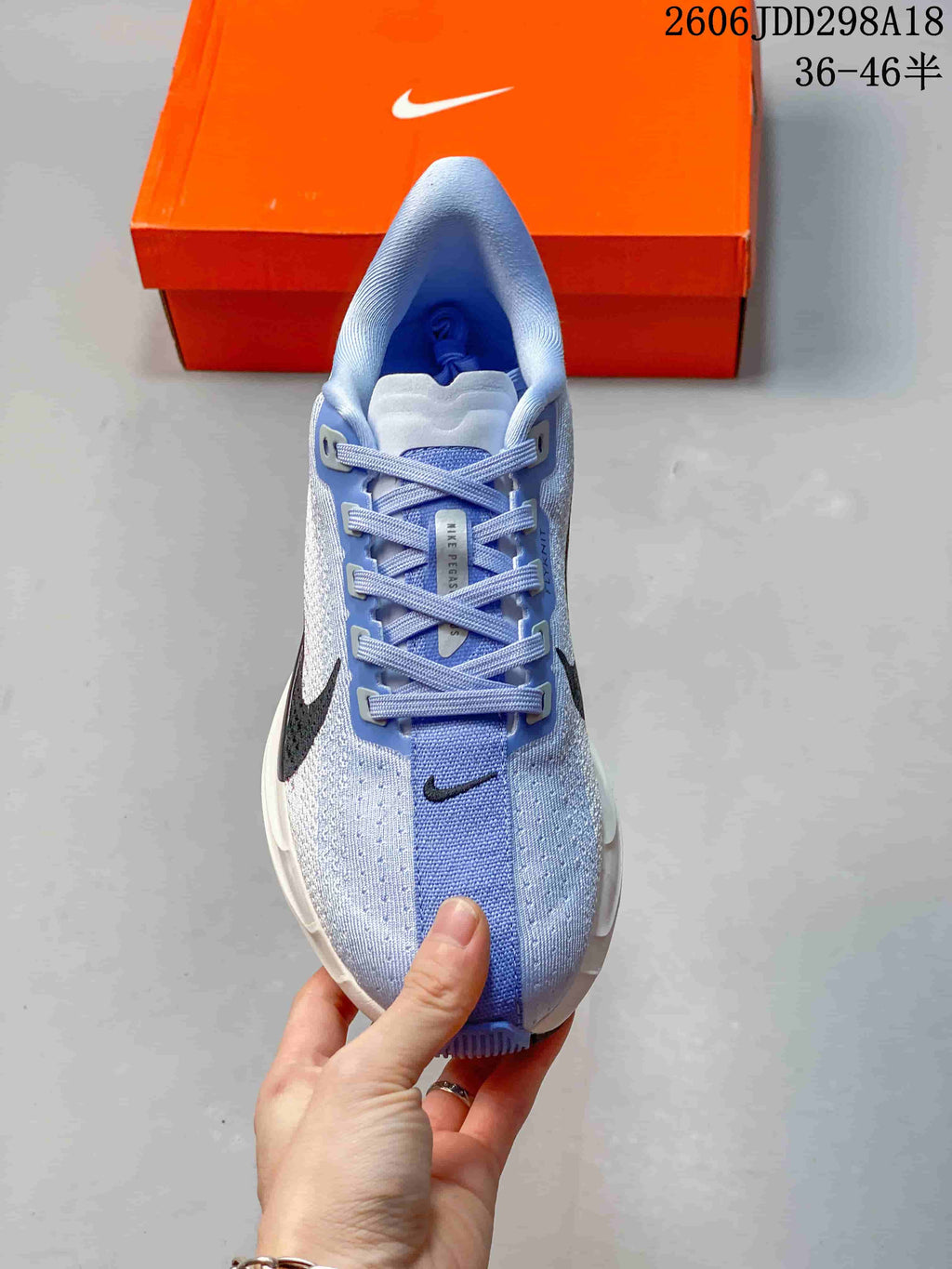 Top view of the light blue Nike running shoe showing the lace-up closure, tongue branding and perforated upper panels.
