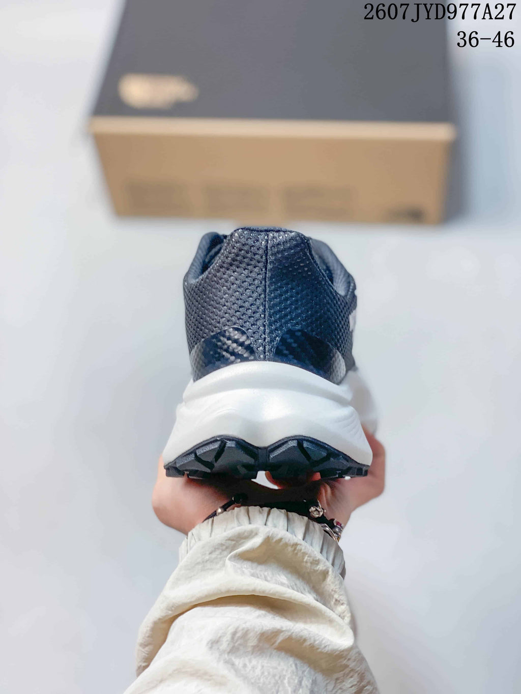 Rear view of the shoe showing the dark mesh heel and white midsole.