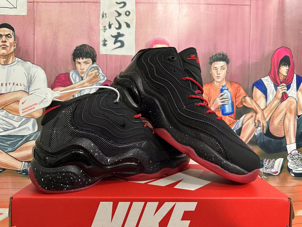 Pair of black Nike basketball sneakers with red accents shown on a red shoe box.