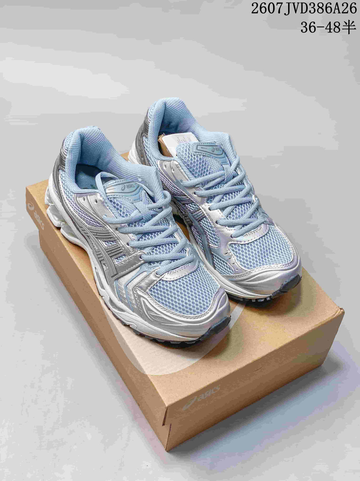 Pair of silver and light blue ASICS GEL-KAYANO 14 sneakers displayed on a shoebox.
