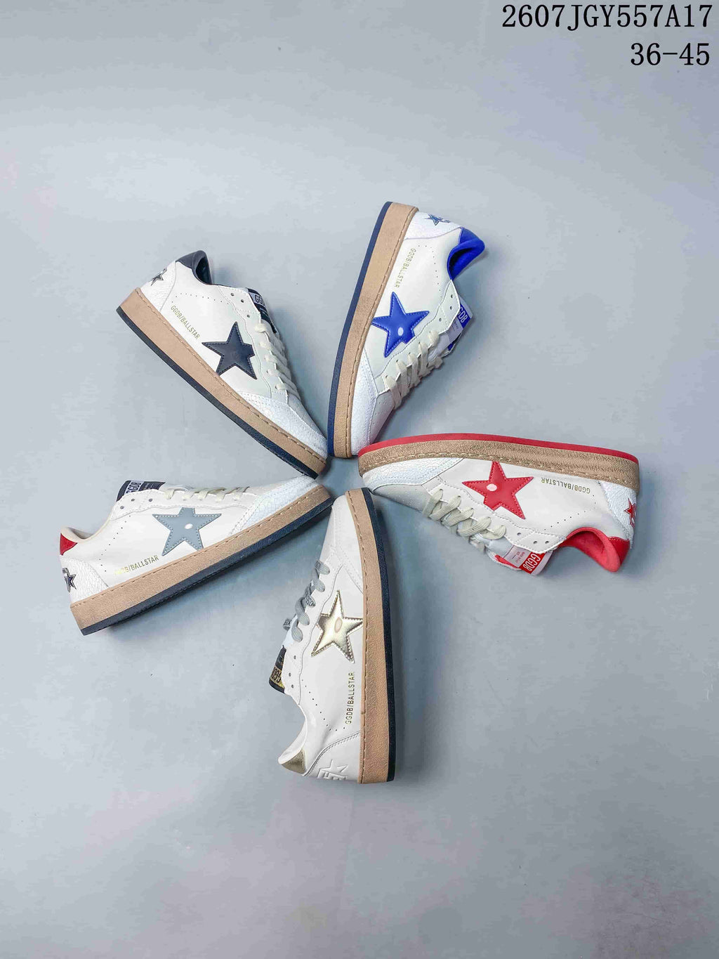 Overhead view showing multiple white Golden Goose Ball Star colorways arranged together, including blue, red, gray, navy, and metallic gold star accents.