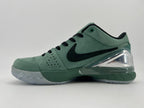 Side profile of the green low-top shoe with black Swoosh and clear heel accent