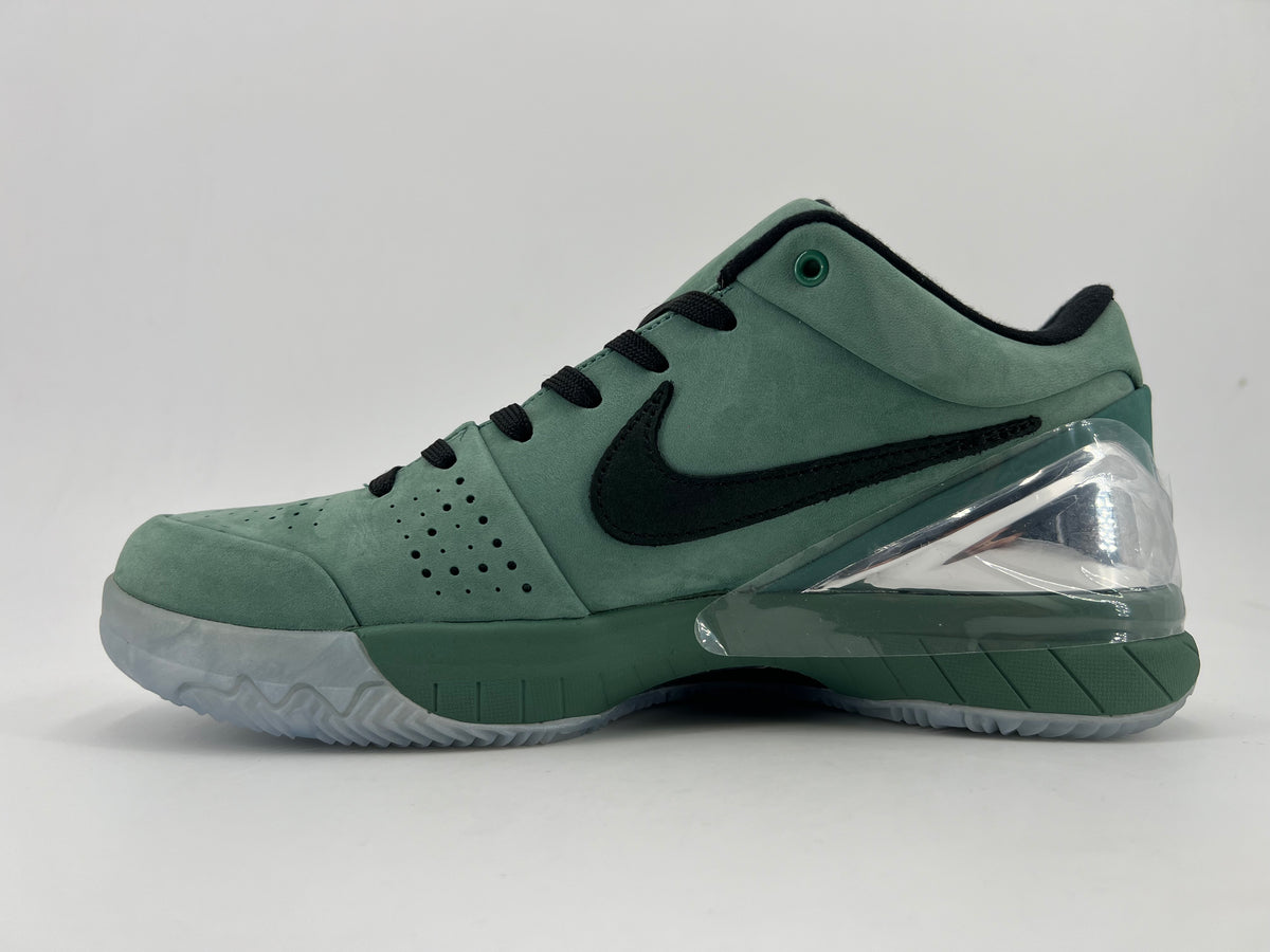Side profile of the green low-top shoe with black Swoosh and clear heel accent