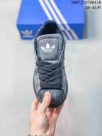 Top view showing the black shell toe, woven laces and Trefoil tongue logo.
