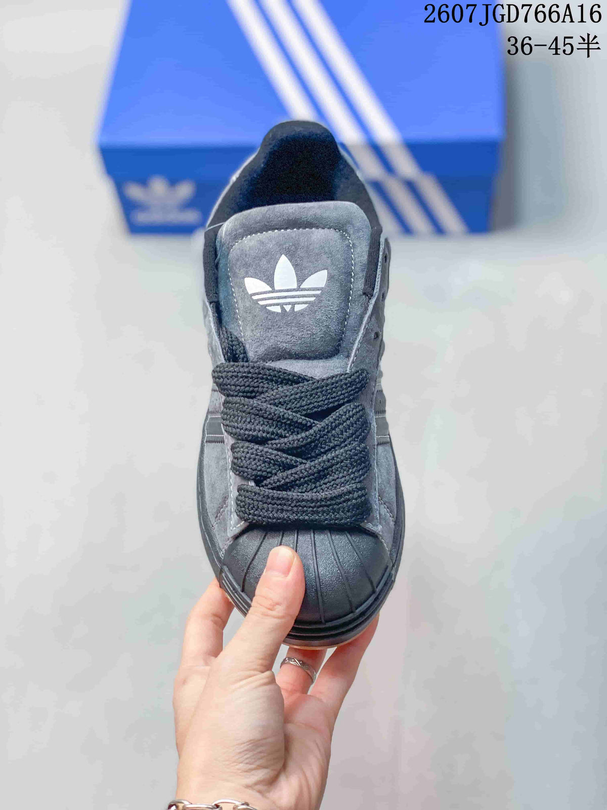 Top view showing the black shell toe, woven laces and Trefoil tongue logo.