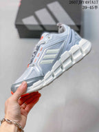 Side view highlighting the mesh upper, layered support panels, three-stripe branding and segmented midsole.