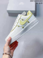 Side view showing the pale yellow Swoosh, white upper and small flower-shaped decorative details.