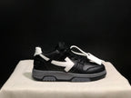 Side profile of a single black sneaker with a white arrow detail, contrasting heel accent, and white lace accessory.