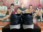 Rear view of dark Nike basketball shoes with patterned collars, white midsoles, and red outsole details