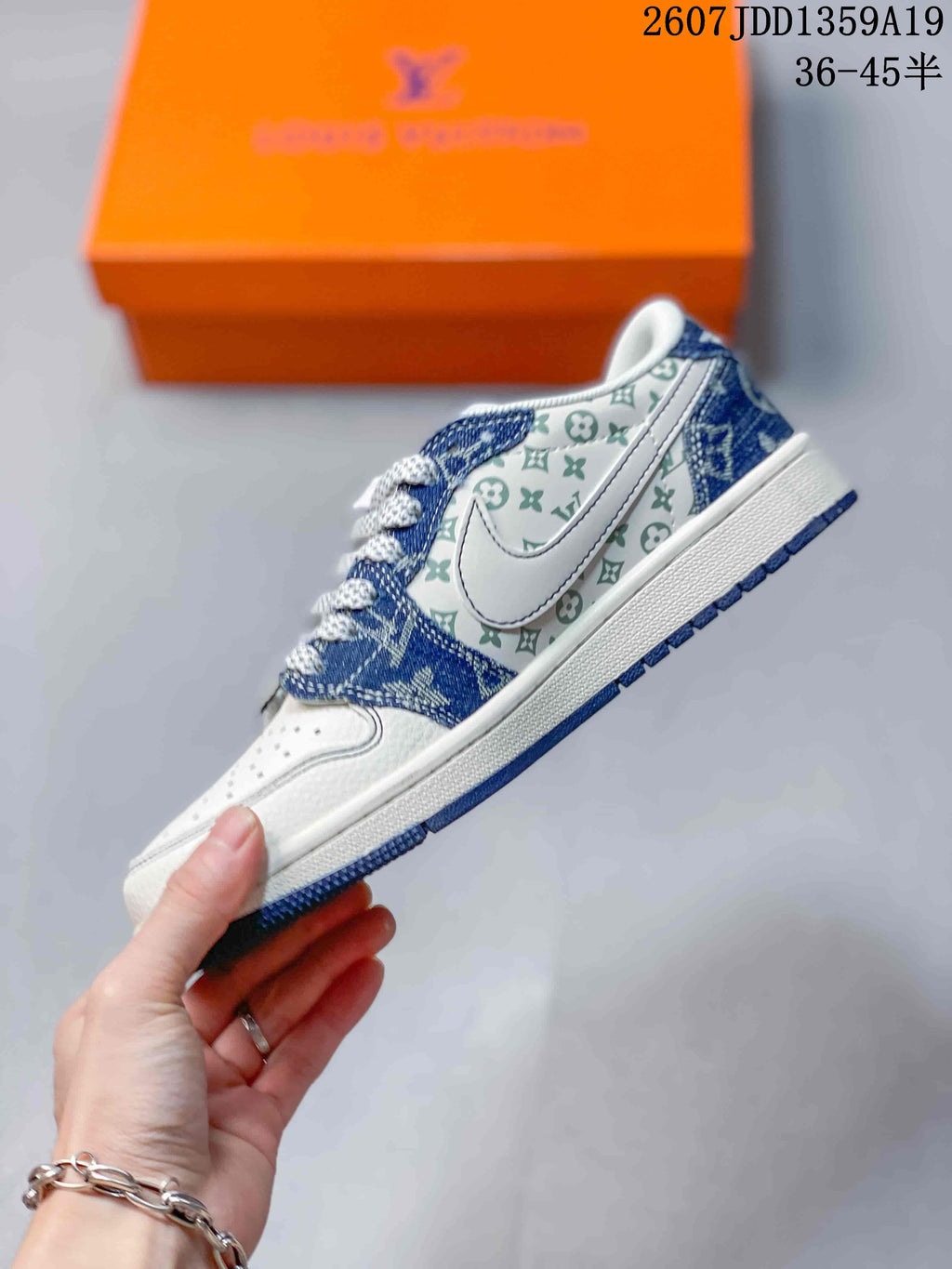 Side profile showing the white upper, blue patterned overlays, large side logo, and blue outsole.