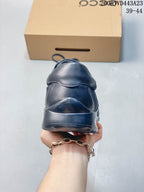 Rear view of the dark navy sneaker and heel