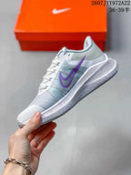 Side view of a light gray Nike Air Zoom Winflo 8 shoe with purple Swoosh detailing, mesh-style upper, laces, and ribbed midsole.