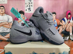 Pair of gray Nike basketball shoes showing the side panels, laces, and forefoot straps