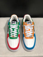 Front view showing the red and blue toe panels, green and orange lace sections, and metal lace details.
