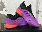 Pair of purple, black and coral adidas Dame 9 basketball shoes