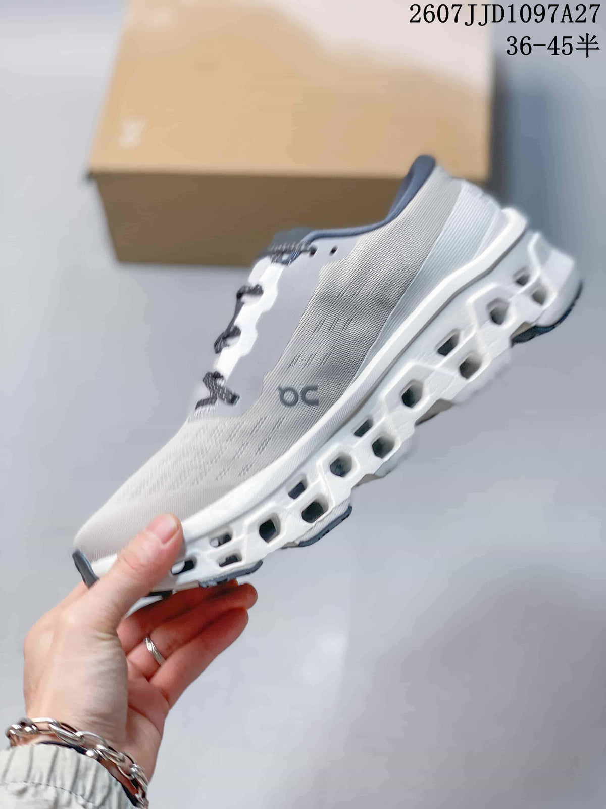 Side profile of the white and gray sneaker highlighting the textured upper and open pod-style midsole.