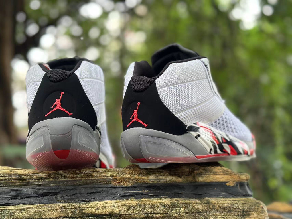 Rear view of the shoes showing black heel panels and red Jumpman-style heel graphics.