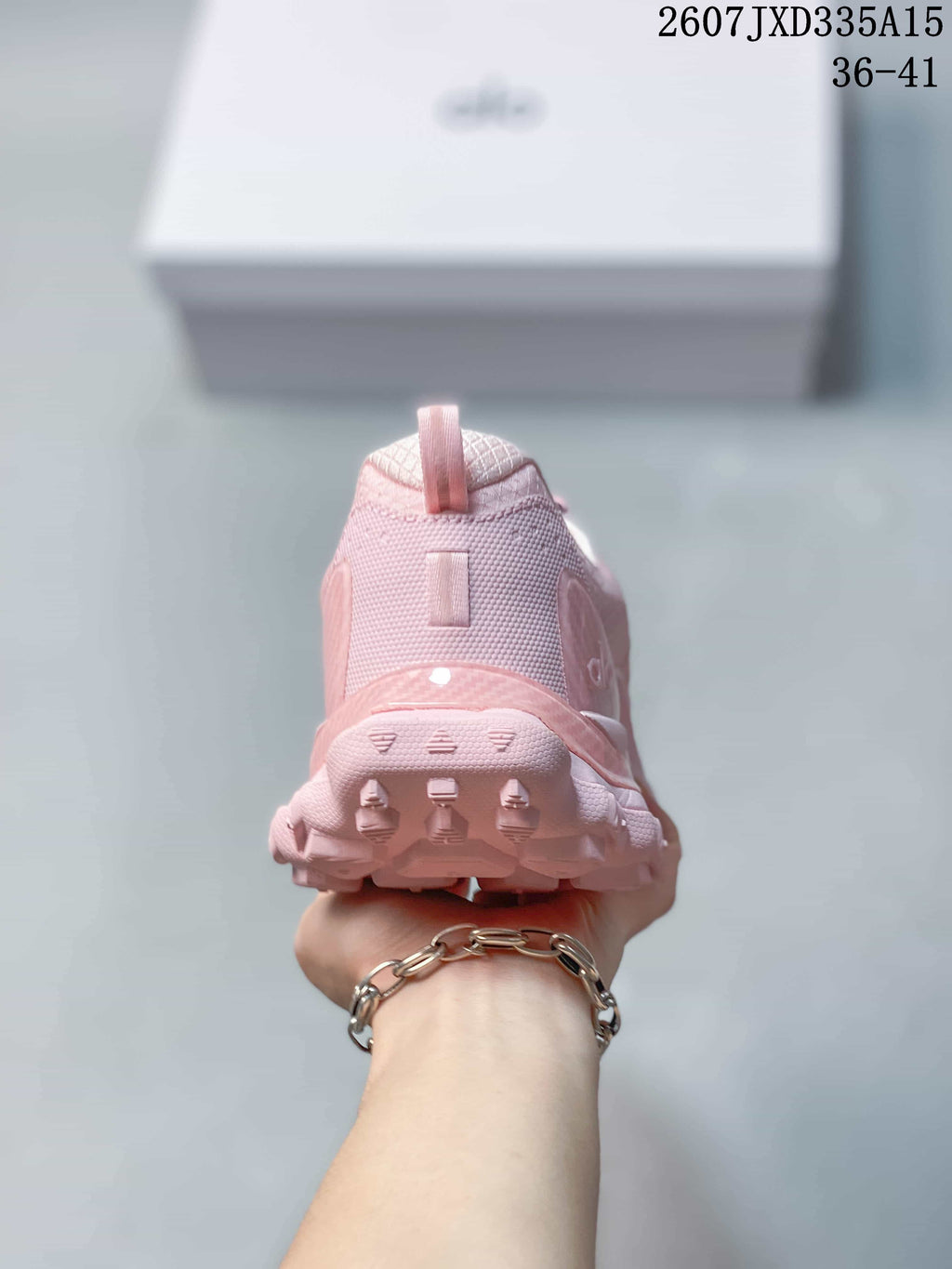 Rear view of the pink sneaker showing the padded heel collar, pull tab and outsole tread.