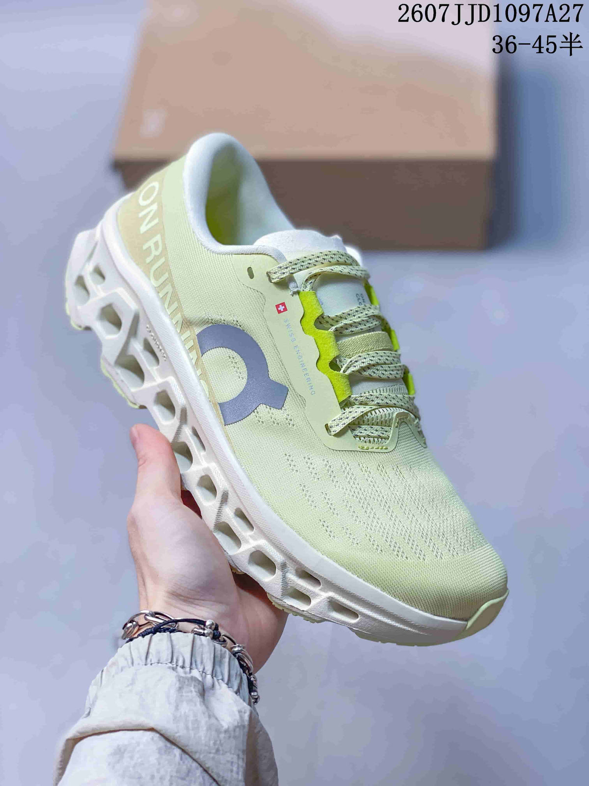 Angled side view of the pale green On sneaker showing the grey logo, heel branding and sculpted outsole.