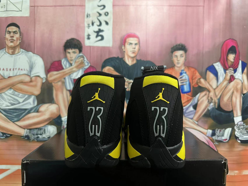 Rear view of black and yellow Jordan high-top sneakers with heel number 23
