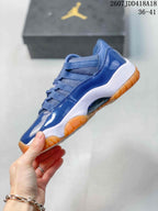 Side profile of the blue high-top sneaker showing the glossy upper, mesh sections, white midsole, and orange outsole.