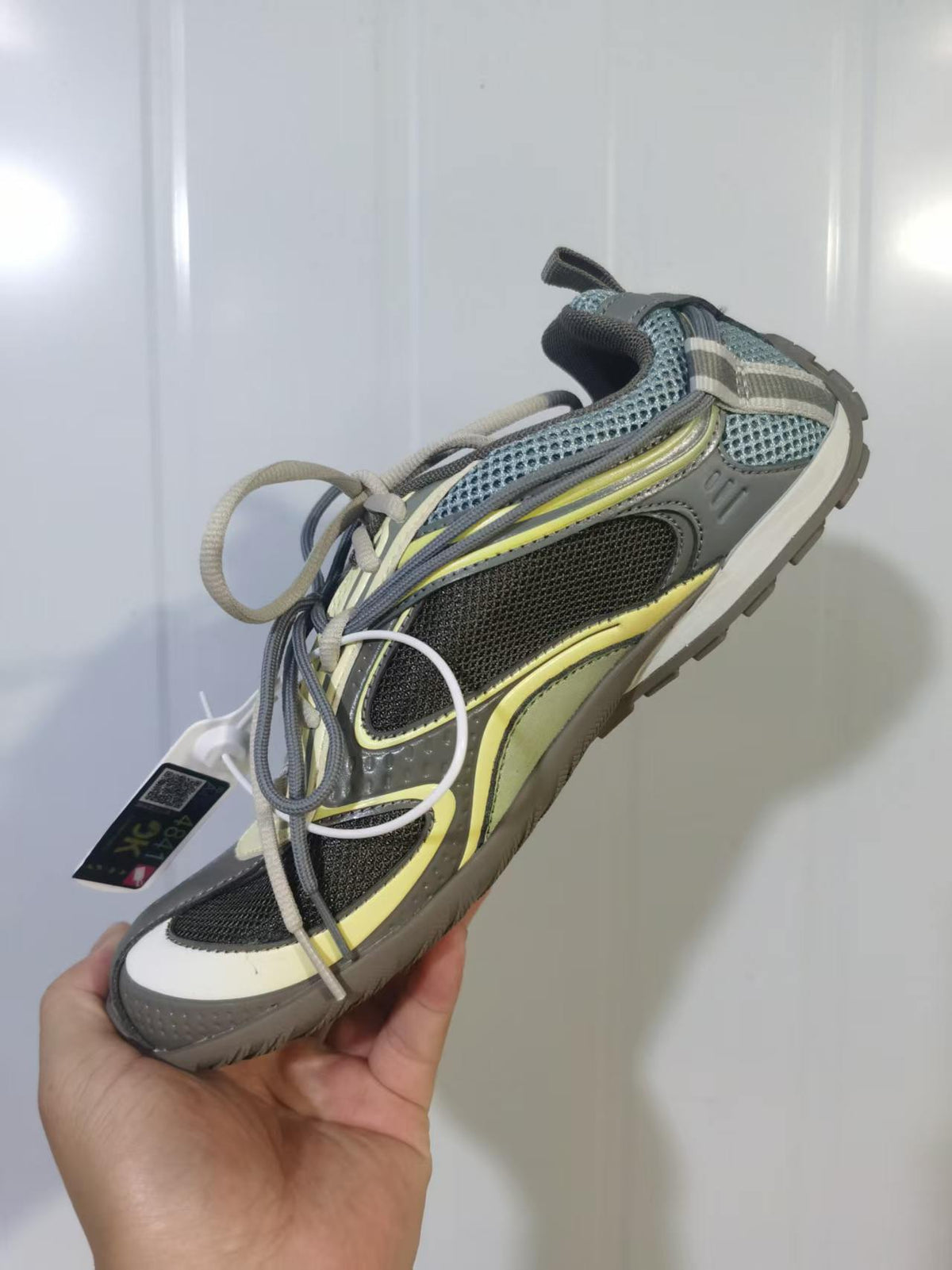 Top and side view of the Balenciaga Radar sneaker showing layered panels, mesh sections, and contrasting laces.