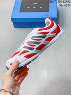 Side profile of the red and white adidas Adizero sneaker