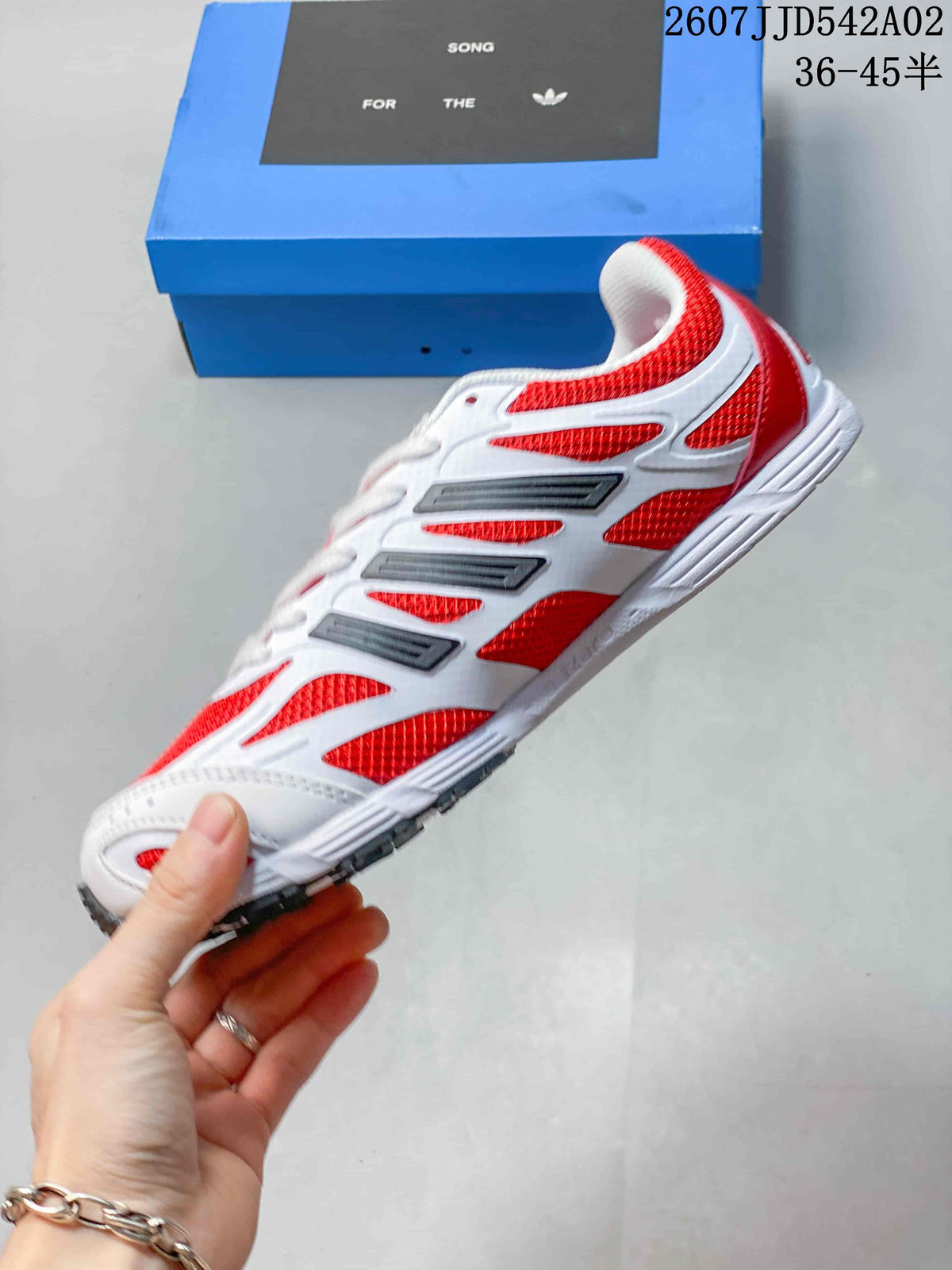 Side profile of the red and white adidas Adizero sneaker
