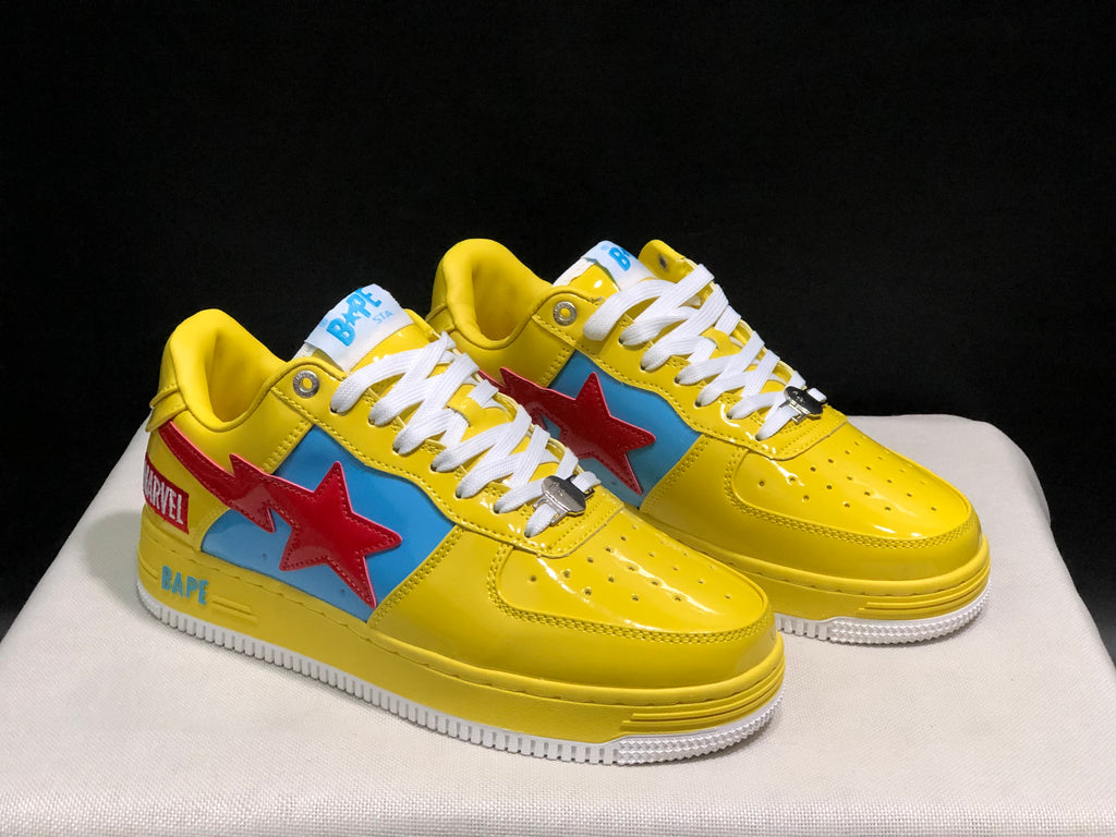 Three-quarter front view of the pair highlighting the yellow uppers, blue side panels, red star details, and white laces.