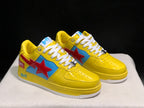 Three-quarter front view of the pair highlighting the yellow uppers, blue side panels, red star details, and white laces.