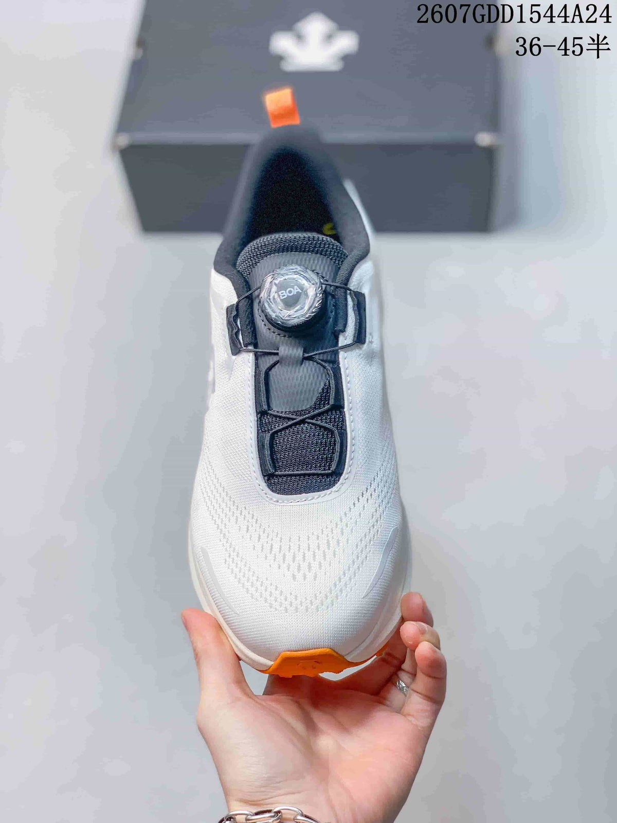 Top view of the white sneaker with a black tongue and BOA-style dial closure.