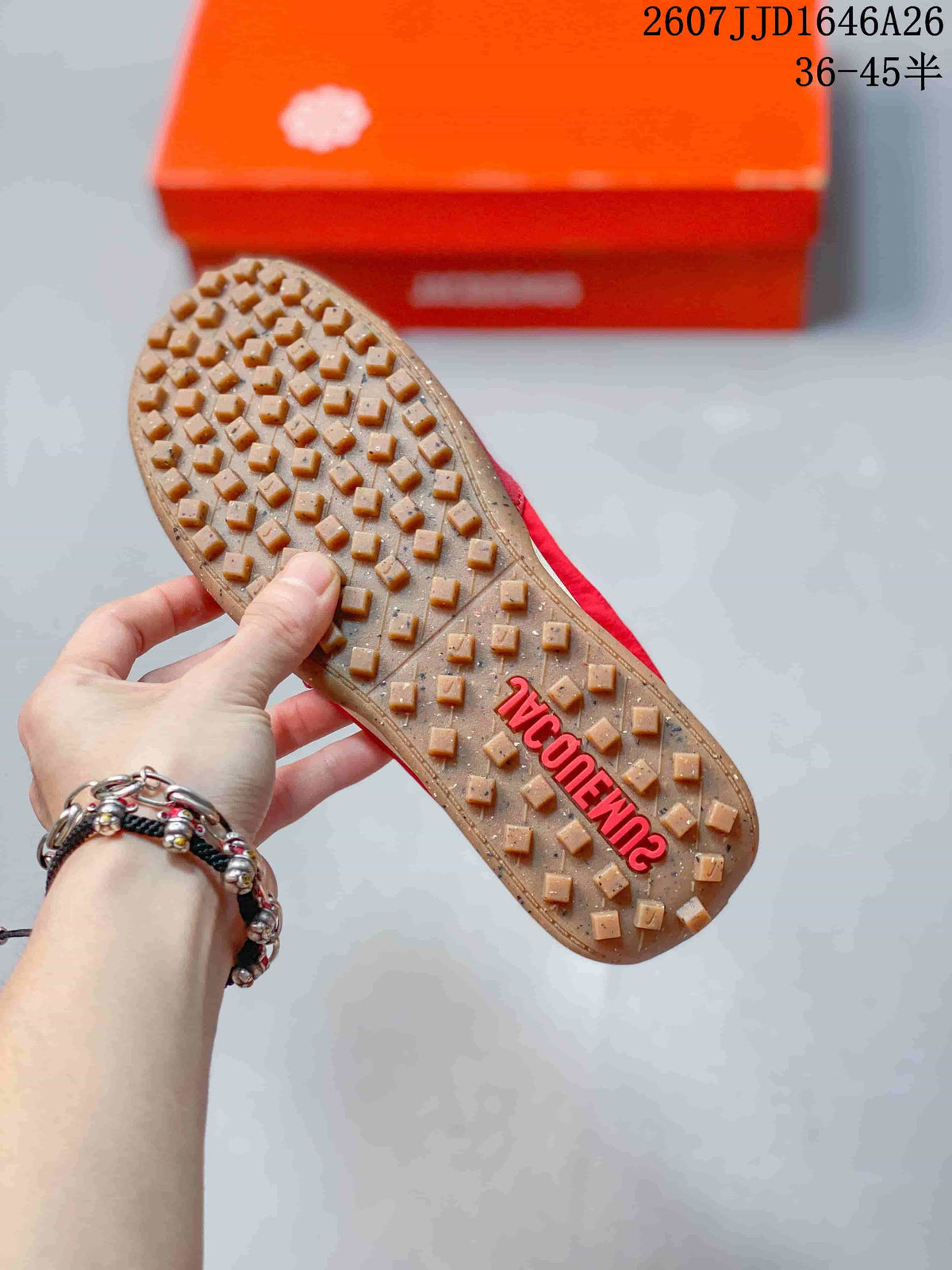 Close view of the gum-colored outsole showing raised square traction lugs and red lettering.