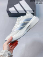 Side profile of the white low-top sneaker showing layered light blue-gray side stripes and a raised midsole.