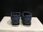 Rear view of the pair showing padded ankle collars, dark heel panels, and cream outsole edges.