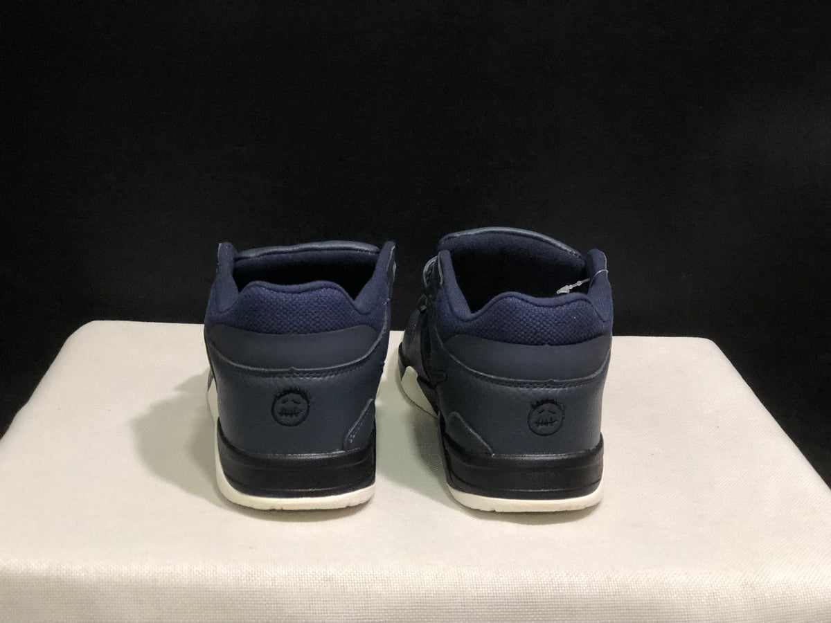 Rear view of the pair showing padded ankle collars, dark heel panels, and cream outsole edges.