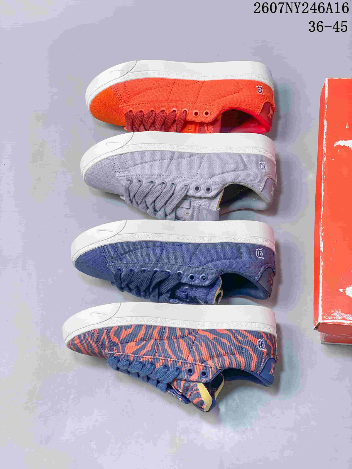 Four Nike sneaker colorways arranged side by side: orange, lavender, blue, and blue-orange tiger stripe.