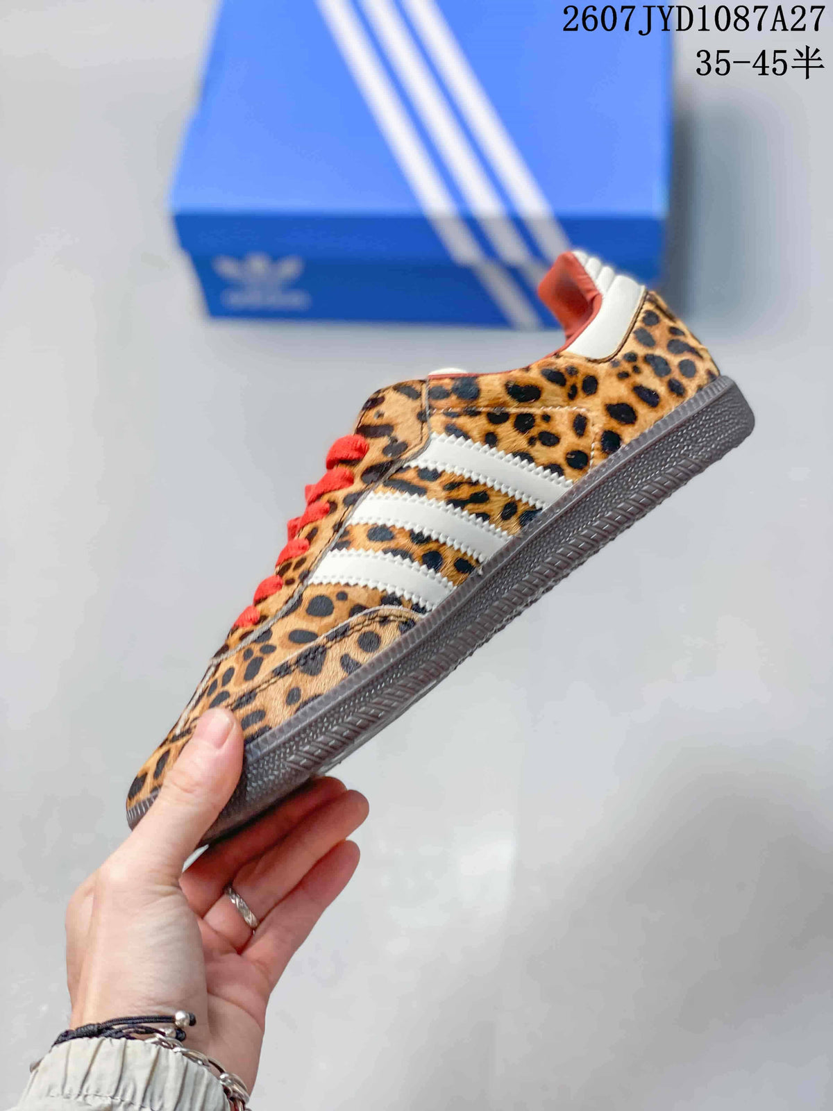 Side profile showing the leopard-print upper, white three stripes, red laces, and low textured outsole.