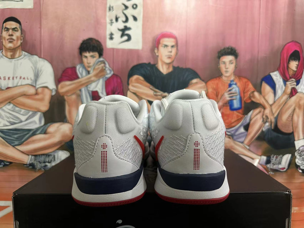 Rear view of white Nike basketball shoes with red heel details and a dark midsole accent.