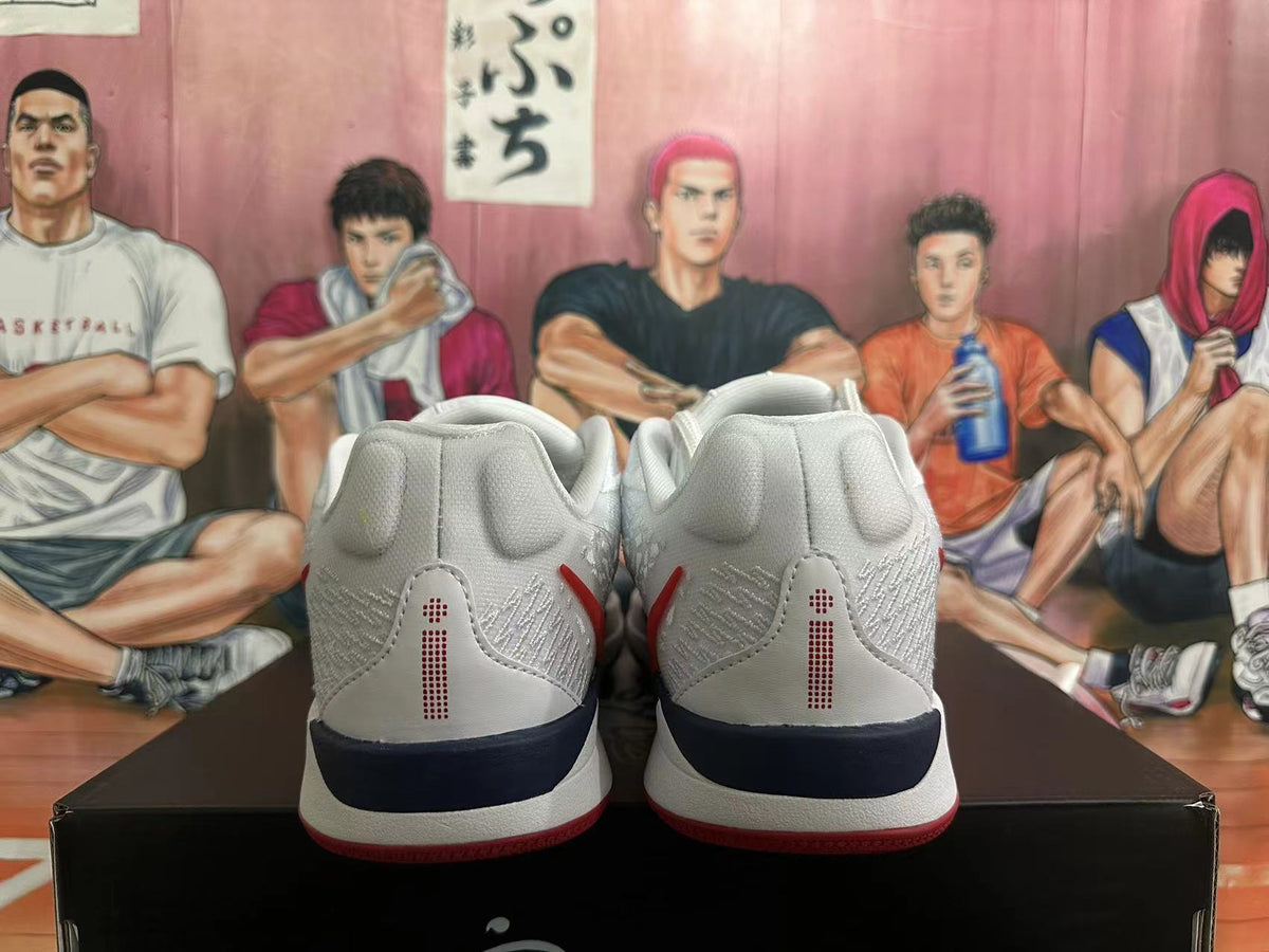 Rear view of white Nike basketball shoes with red heel details and a dark midsole accent.