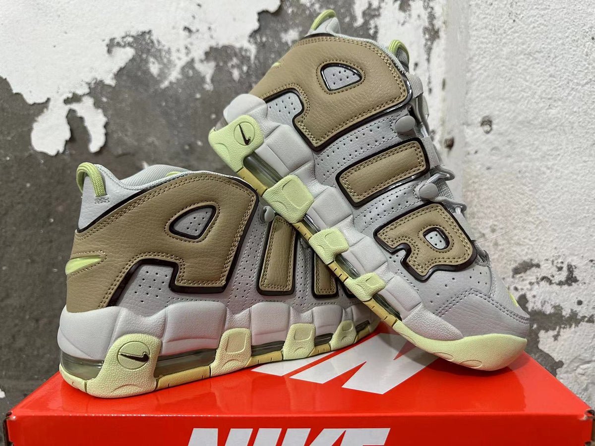 Pair of gray and brown Nike sneakers with oversized AIR lettering and light lime accents.