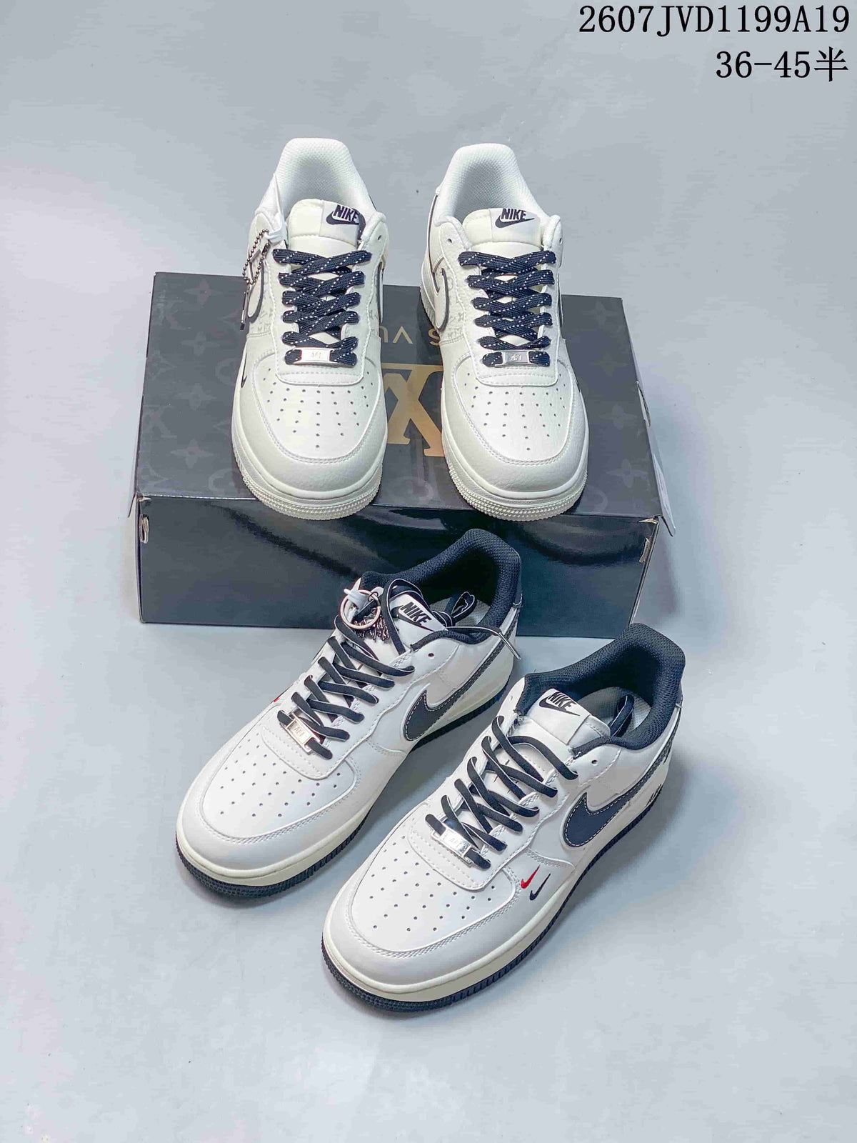 Multiple views of the white Nike sneaker pair showing perforated toe boxes, dark laces, contrasting Swooshes, patterned panels, and decorative lace accessories.