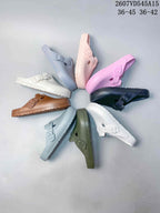 Group display showing the sandal in white, light blue, pink, purple, black, brown and olive green colorways.