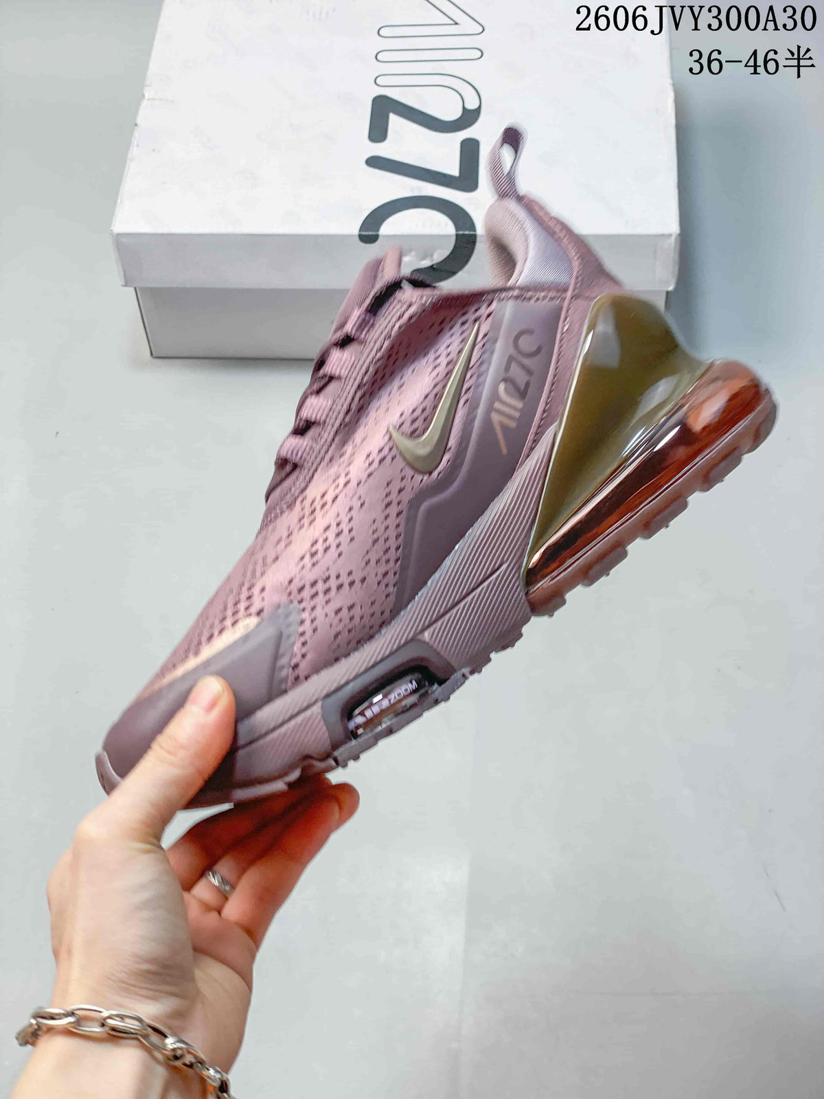 Side view of the mauve sneaker with a prominent heel air unit