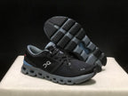 Angled view of the shoes with one outsole lifted to show the tread pattern.